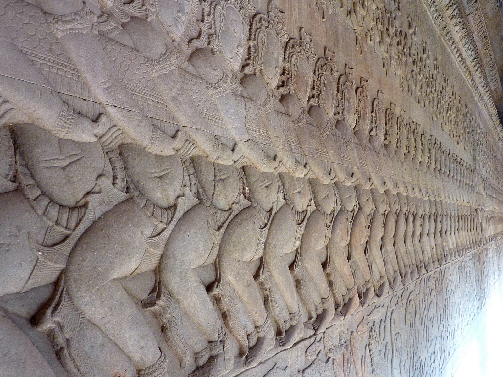A row of carved warriors and elephants from the Churning of the Ocean of Milk, one of Angkor Wat's 49-meter bas-relief galleries. Photo: Anandajoti, CC BY 3.0, via Wikimedia Commons.