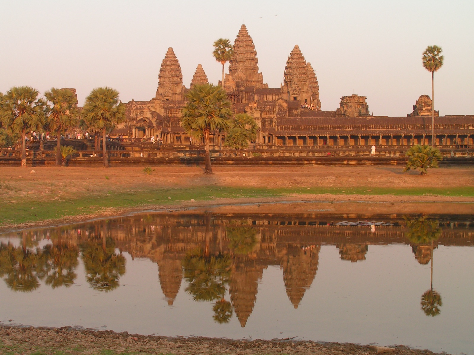 Angkor Wat's five central towers reflected in the temple's moat at dawn. Photo: David Wilmot, CC BY 2.0, via Wikimedia Commons.