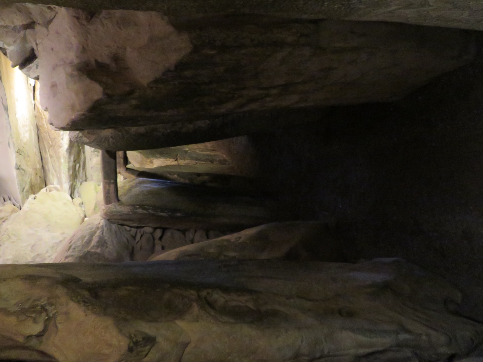 Looking along Newgrange's stone passage toward the corbelled chamber — the nineteen-meter route the midwinter sunbeam travels. Photo: O'Dea, CC BY-SA 4.0, via Wikimedia Commons.